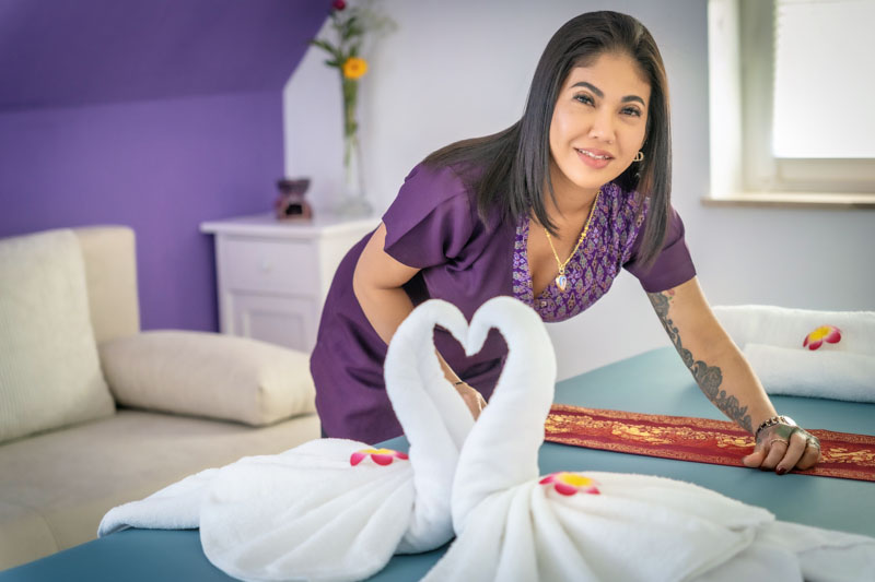 Die Masseurin Nitchapa bereitet eine Liege für die nächste Thai Massage vor